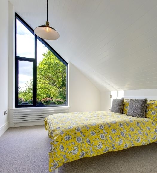 gable end window paired with a casement window in a bedroom