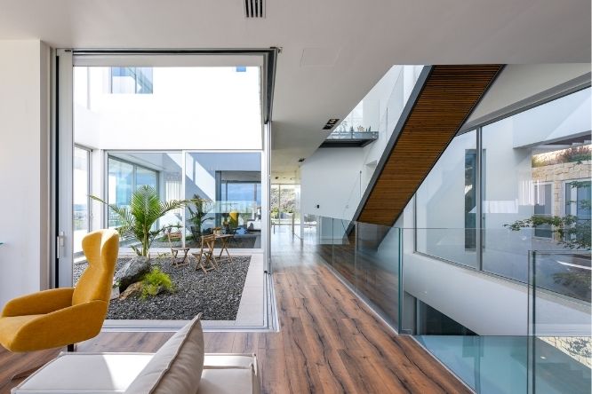 luxury modern villa house design - sliding glass doors and frameless glass balustrade