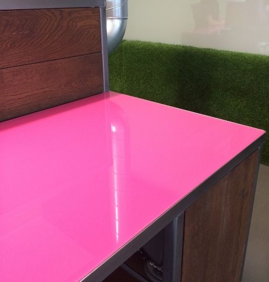 pink back painted glass used in an office for a desk - pink glass - decorative glazing
