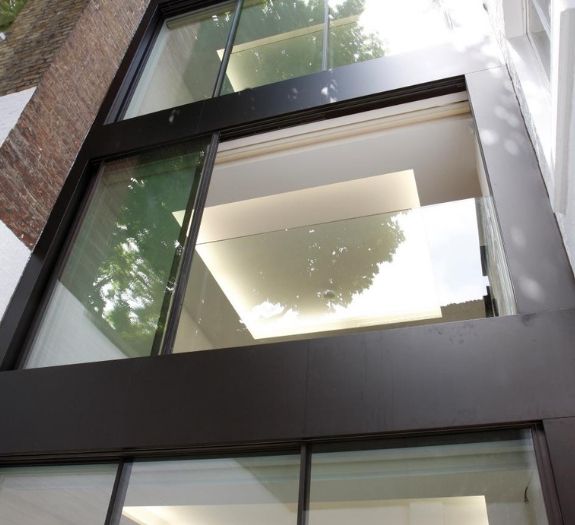 contemporary juliet balcony design with sliding glass doors and a frameless glass balustrade