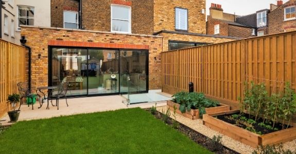 external view of three pane sliding glass patio door on a london home rear extension