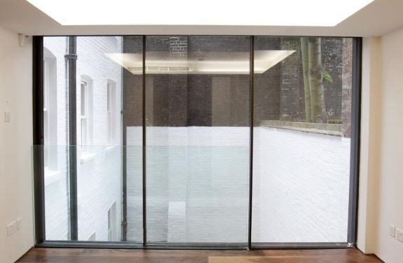 three pane sliding glass door and a frameless glass balustrade used in a modern juliet balcony design