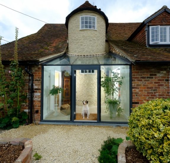 period property in the English countryside with a modern glass extension using an aluminium casement door and structural glazing
