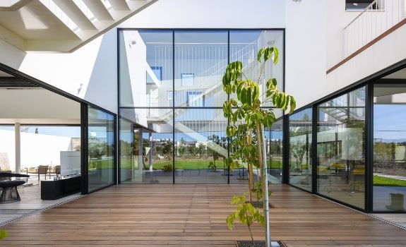 double height window design and large sliding glass doors that allows in vast amounts of natural light whilst providing clear views of the nature outdoors