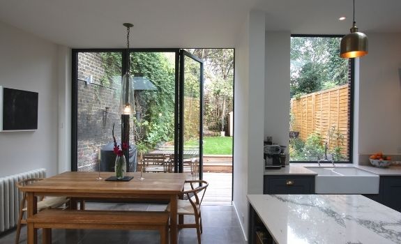 three pane aluminium bifold door and large fixed casement window with low maintenance coatings to create easy clean glass