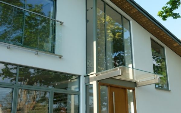 green window frames and grey framed windows and doors for a contemporary glazing style on a new build home