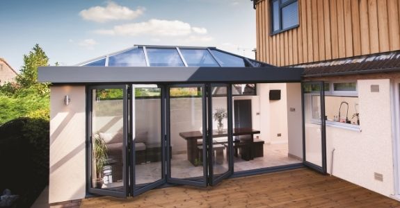 Roof lantern and aluminium bifolding patio doors use to maximise natural light in this home