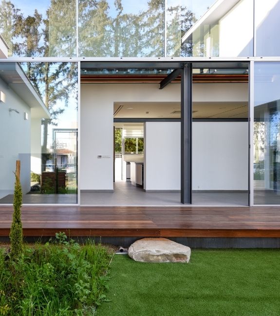 Sieger slim sliding door used in a glass façade at the rear of a modern villa house