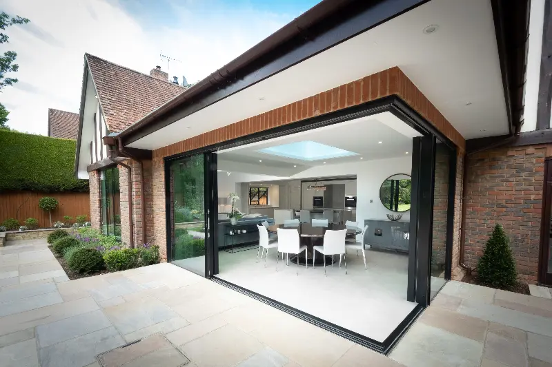 modern extension on a traditional home with open corner slim sliding glass doors