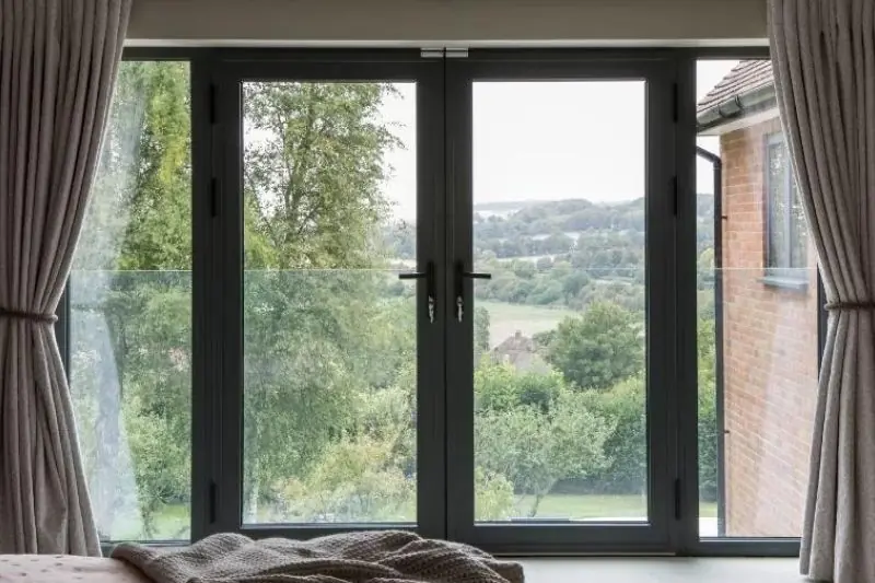 internal view of a modern Juliet balcony with Schuco aluminium casement doors and fixed sidelights