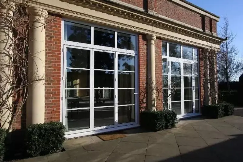 white framed bifold door with slim aluminium frames and glazing bars for a steel look effect