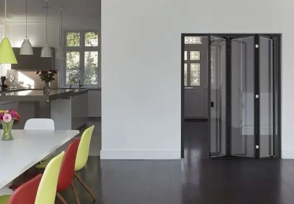 internal glass bifold door used to create a broken plan living space in a family home