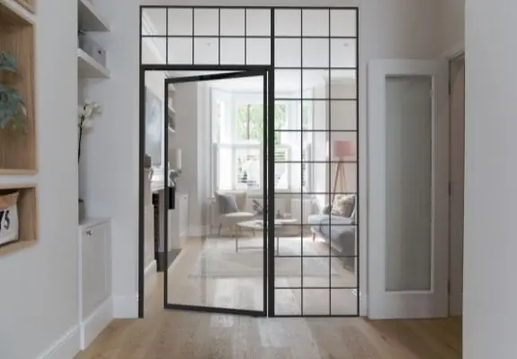 internal glass pivot door an fixed glazing used to create a broken plan living space in a family home