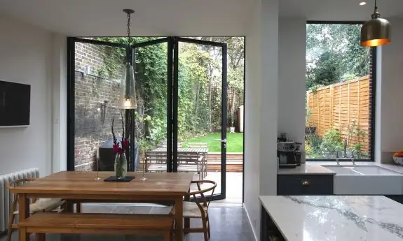 three pane bifold door and large picture window in a modern home extension